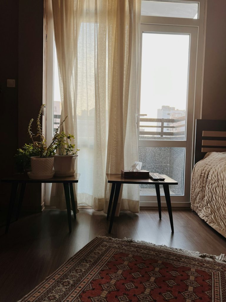 a-bedroom-with-a-bed-and-a-rug-in-front-of-a-window-neq4kv1oqty Home